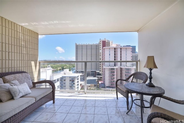 balcony with a city view and an outdoor hangout area