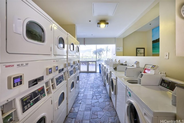 common laundry area with stone finish floor, stacked washer / dryer, and independent washer and dryer