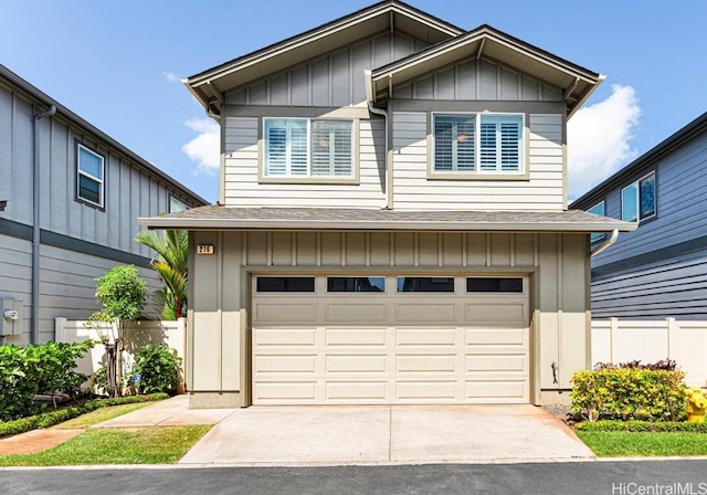 view of front of property with concrete driveway, an attached garage, board and batten siding, and roof with shingles