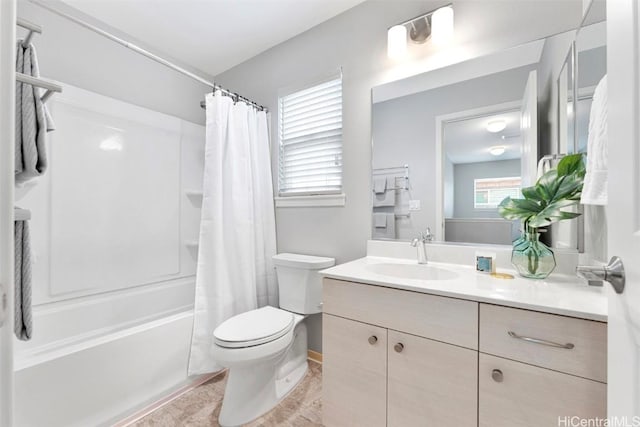 full bath featuring shower / bath combo with shower curtain, toilet, and vanity