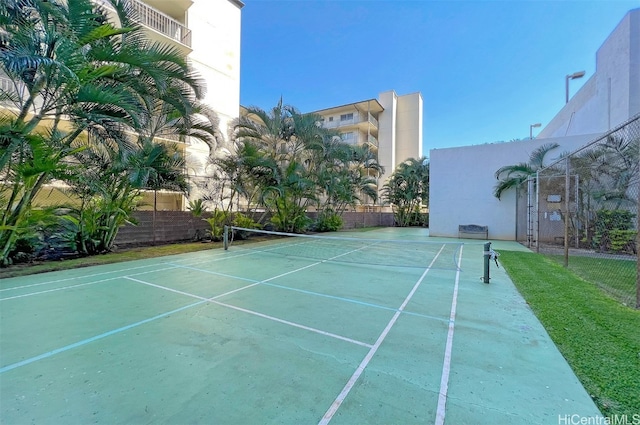 view of tennis court with fence