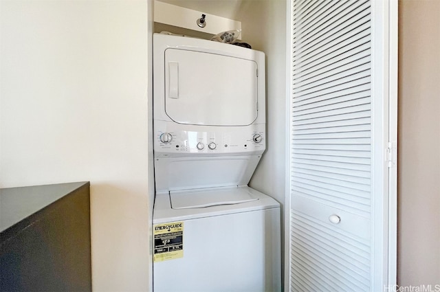 laundry area with laundry area and stacked washer / drying machine