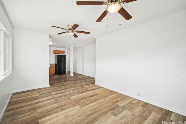 spare room with light wood-type flooring and baseboards