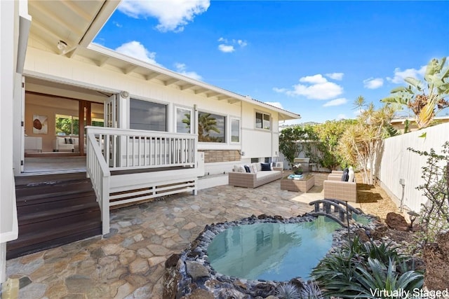 rear view of house with a fenced backyard, outdoor lounge area, a fenced in pool, and a patio