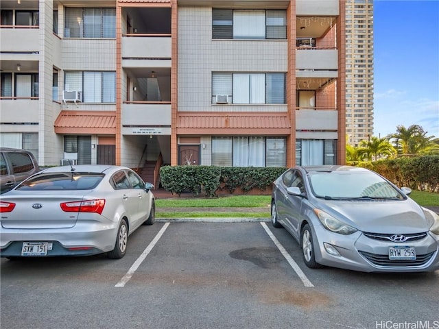 view of property featuring uncovered parking