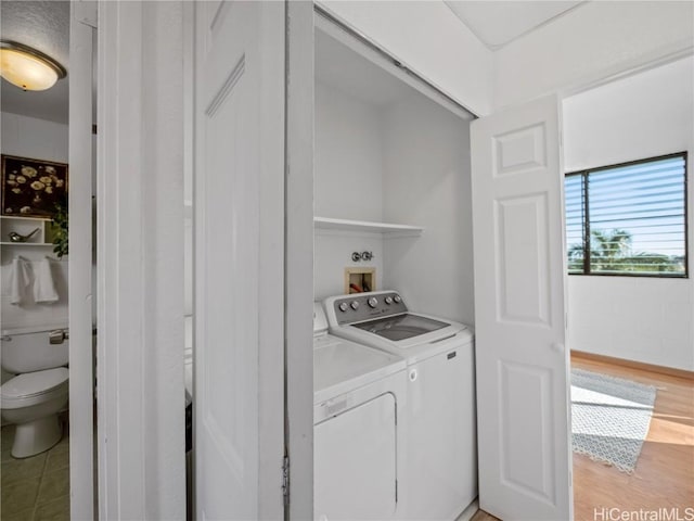 laundry area featuring laundry area, independent washer and dryer, and light wood-style flooring