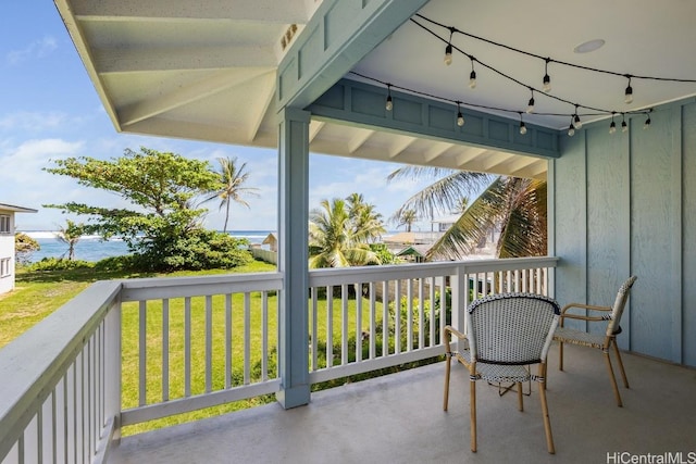 view of patio / terrace featuring a water view and a balcony