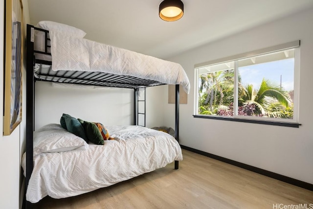 bedroom with light wood-style flooring and baseboards