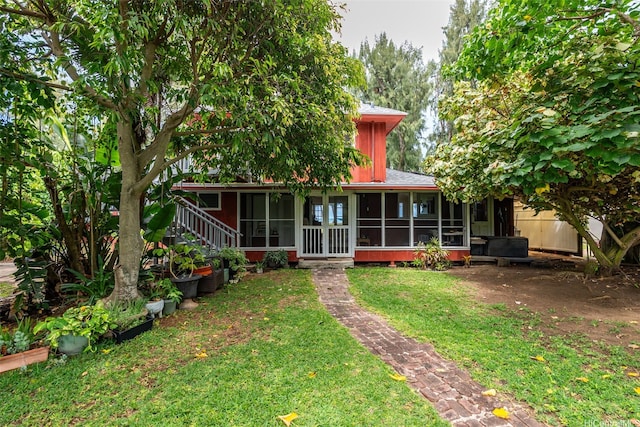 41-949 Laumilo St, Waimanalo, HI 96795 - back of house with a sunroom and a lawn