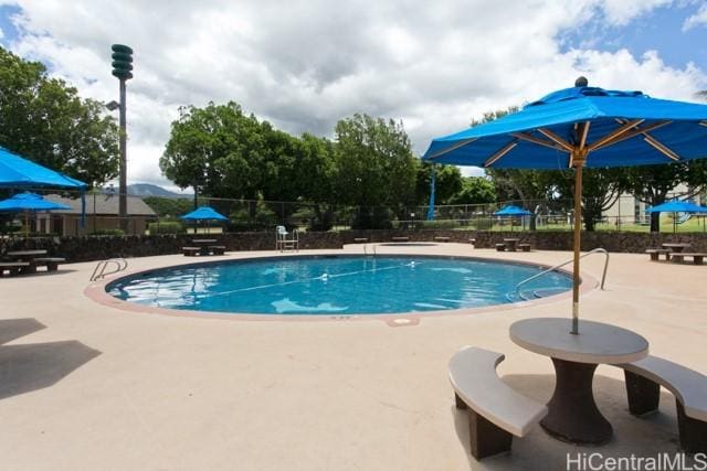 pool featuring a patio and fence