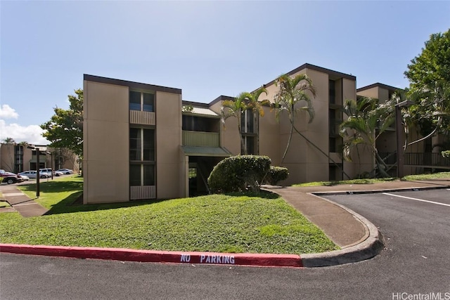 view of building exterior with uncovered parking