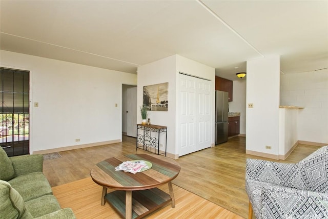 living area with baseboards and light wood-style floors