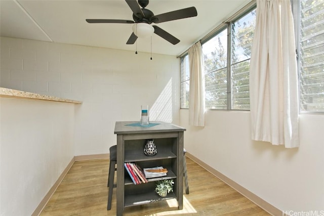 interior space featuring baseboards and wood finished floors