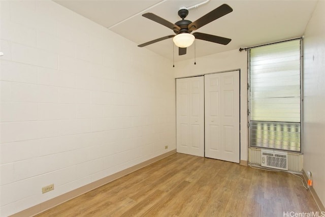 unfurnished bedroom featuring a closet, ceiling fan, and light wood-style floors