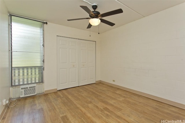 unfurnished bedroom with light wood-type flooring, baseboards, a closet, and ceiling fan