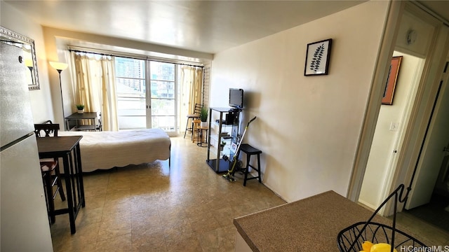 bedroom with freestanding refrigerator