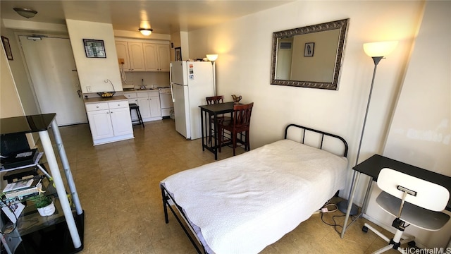 bedroom with freestanding refrigerator