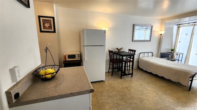 interior space featuring white appliances and dark countertops