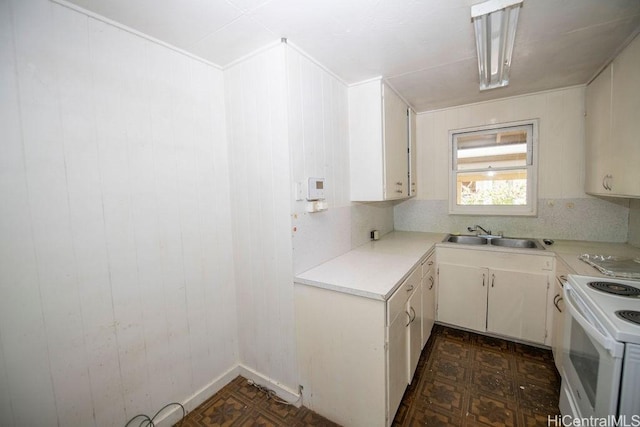 kitchen featuring decorative backsplash, dark floors, light countertops, white electric range, and a sink