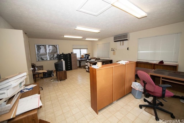 office featuring a wall mounted air conditioner, a textured ceiling, and light floors