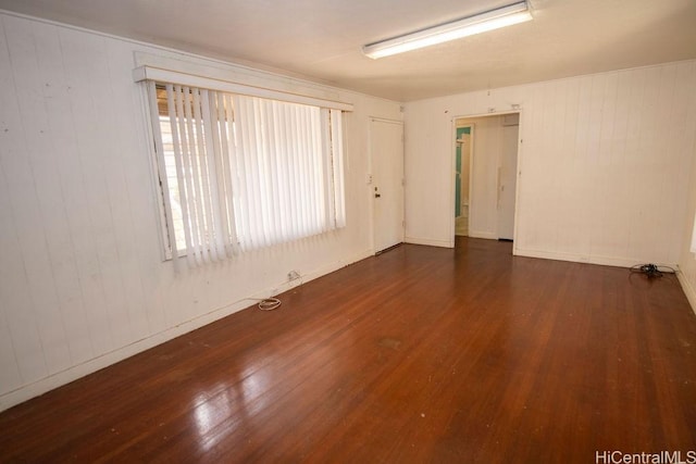 spare room featuring wood finished floors