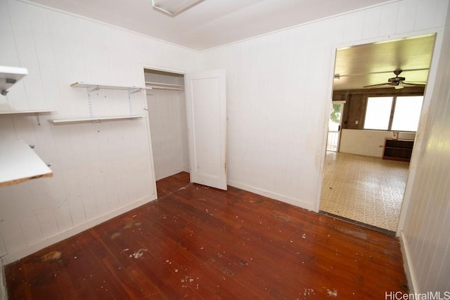 interior space with hardwood / wood-style flooring, baseboards, and a closet