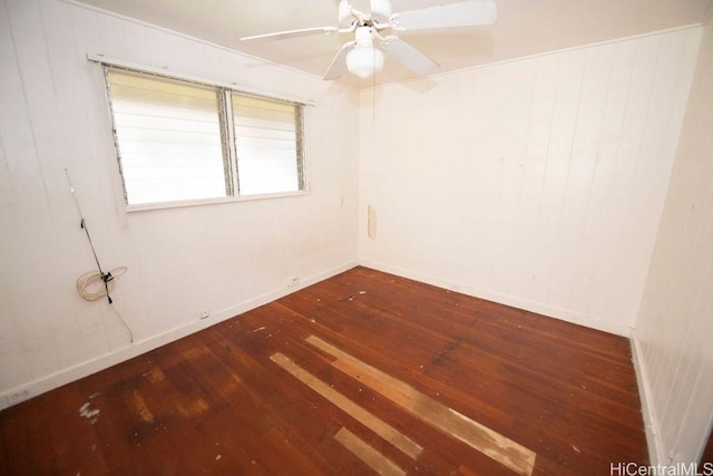 spare room featuring baseboards, a ceiling fan, and wood finished floors