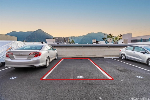 uncovered parking lot featuring a mountain view