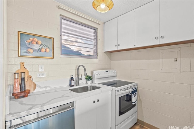 kitchen with white electric range oven, dishwasher, light stone countertops, white cabinetry, and a sink