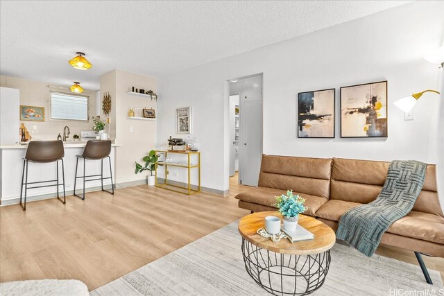 45-342 Lilipuna Rd Unit 307, Kaneohe, HI 96744 - living area featuring light wood-style flooring and a textured ceiling
