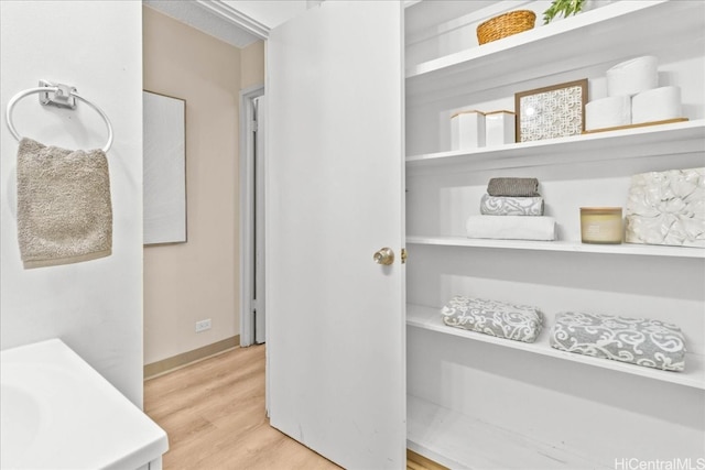 interior space featuring baseboards and wood finished floors