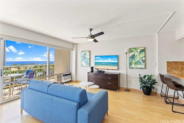 living area with ceiling fan, light wood-style flooring, and baseboards