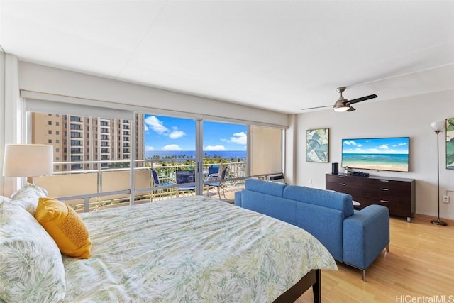 bedroom featuring ceiling fan, light wood-style floors, and access to exterior