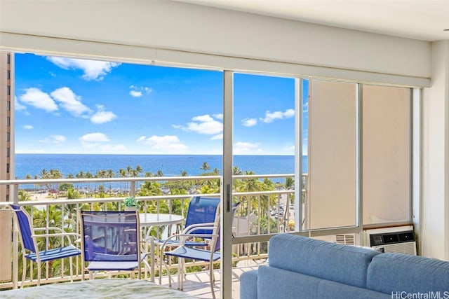 balcony featuring a water view and a wall mounted air conditioner