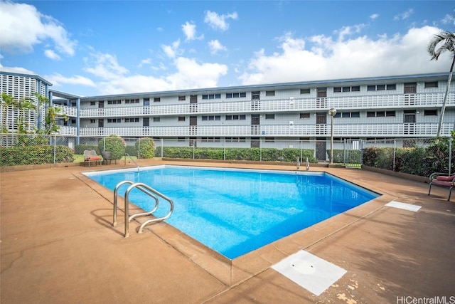 community pool featuring a patio area and fence