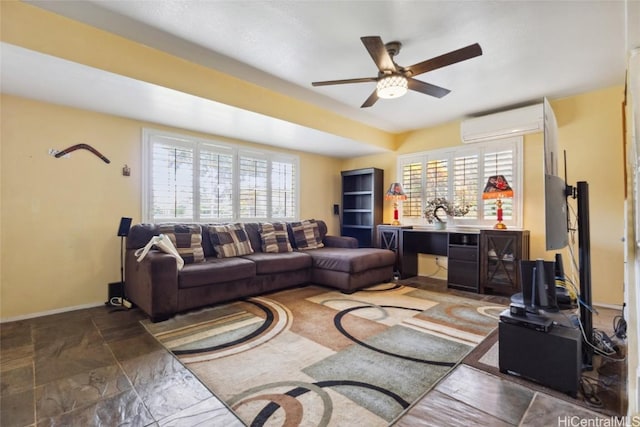 living area featuring an AC wall unit, baseboards, and ceiling fan