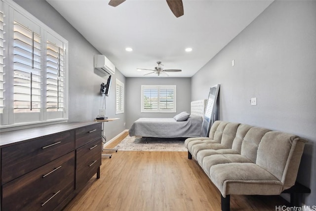 bedroom with a wall mounted AC, recessed lighting, light wood-style floors, baseboards, and ceiling fan