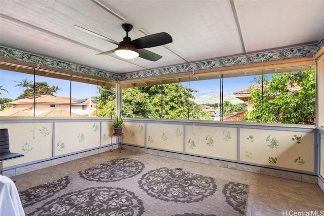 sunroom / solarium featuring plenty of natural light and ceiling fan