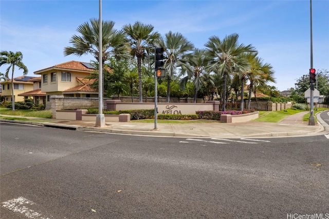 exterior space featuring sidewalks, curbs, and traffic signs