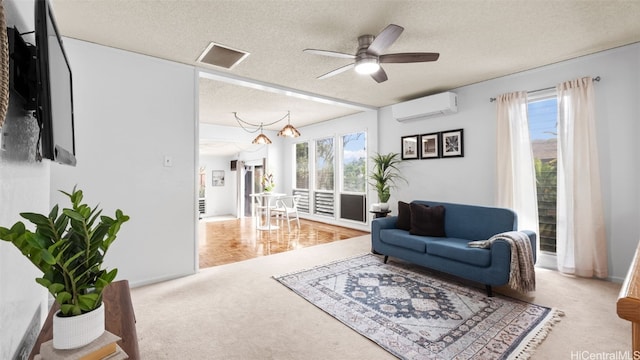 carpeted living area featuring visible vents, a textured ceiling, a ceiling fan, and a wall unit AC