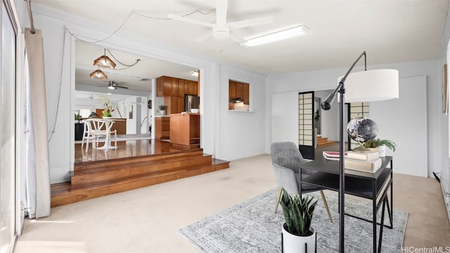 dining space featuring stairway, carpet flooring, and a ceiling fan