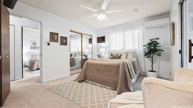 bedroom featuring light carpet, an AC wall unit, a textured ceiling, a closet, and baseboards