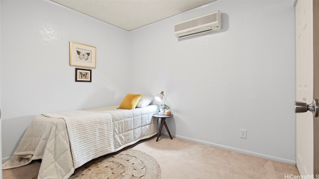 carpeted bedroom with baseboards and a wall unit AC