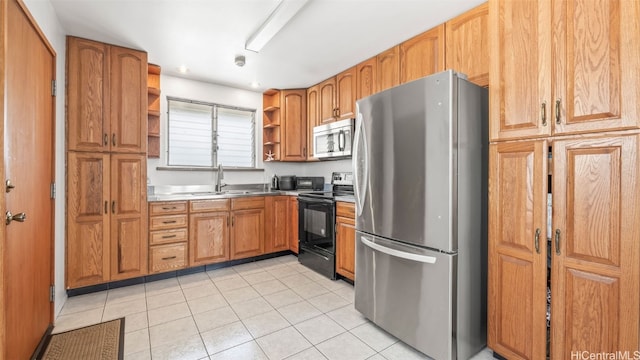 kitchen featuring light tile patterned floors, open shelves, a sink, stainless steel appliances, and brown cabinets