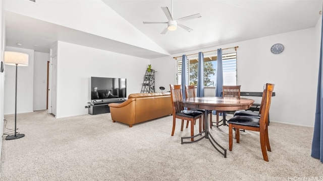 dining space with vaulted ceiling, a ceiling fan, and carpet floors