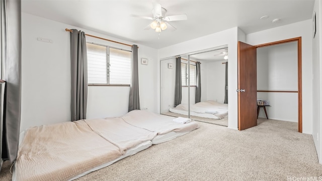 carpeted bedroom with a closet and a ceiling fan