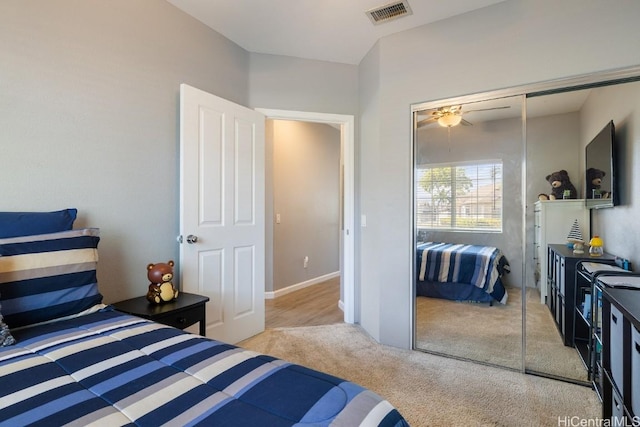 carpeted bedroom featuring visible vents and a closet