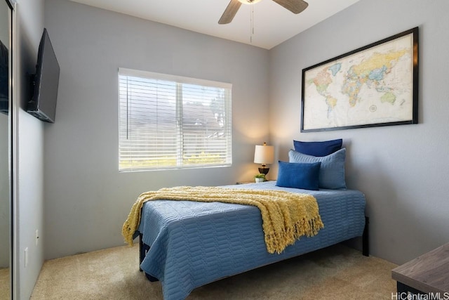 bedroom featuring a ceiling fan and carpet