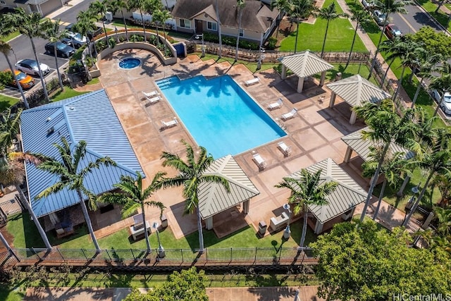 pool featuring a lawn, a patio, a residential view, fence, and a gazebo