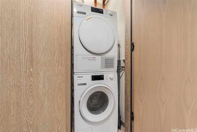 laundry room with stacked washer and clothes dryer and laundry area